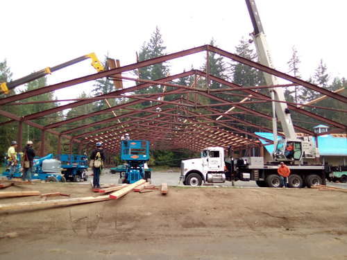 A worksite featuring a building in construction with metal foundation